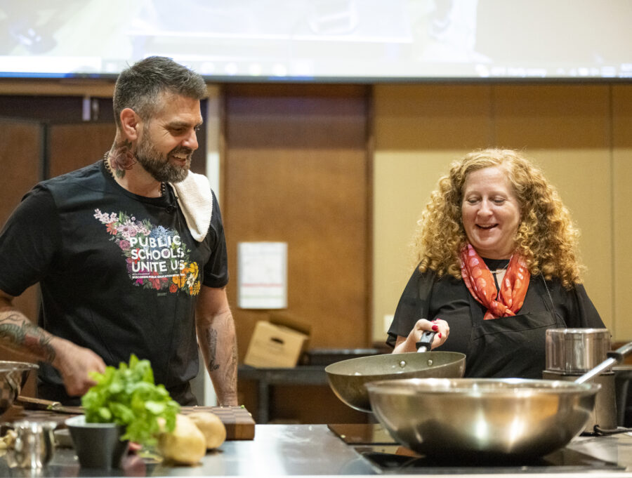 Luke Zahm and Jennifer Mnookin cook together in a pop-up demonstration kitchen.