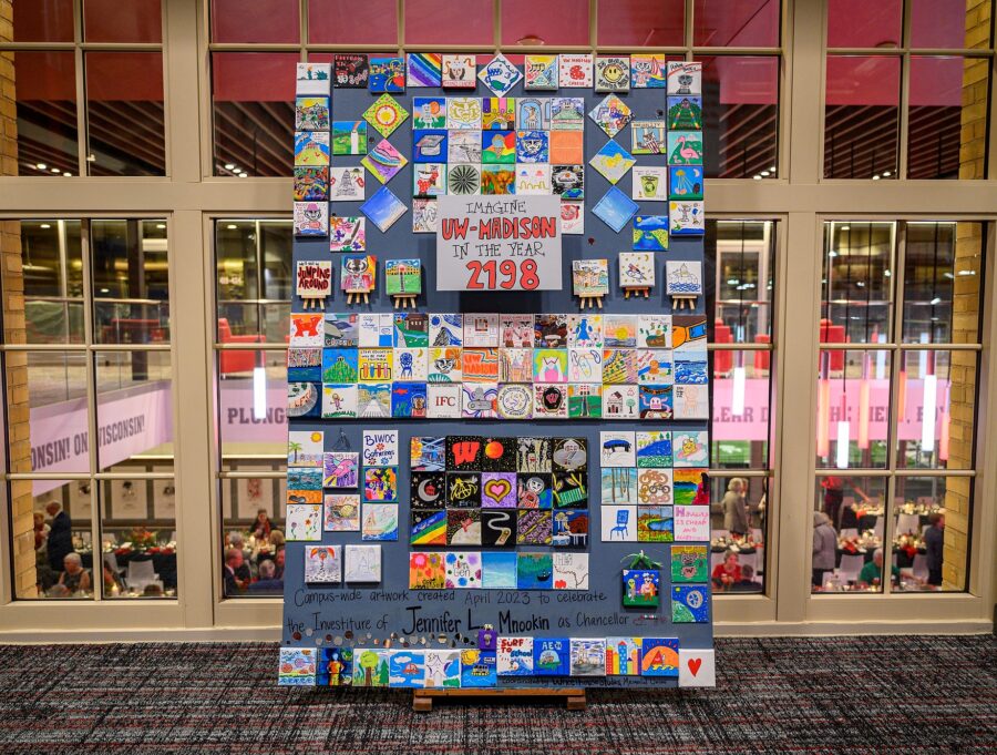 Miniature canvases painted with ideas about what UW–Madison will look like in 175 years are arranged in a random mosaic pattern on a large display board.