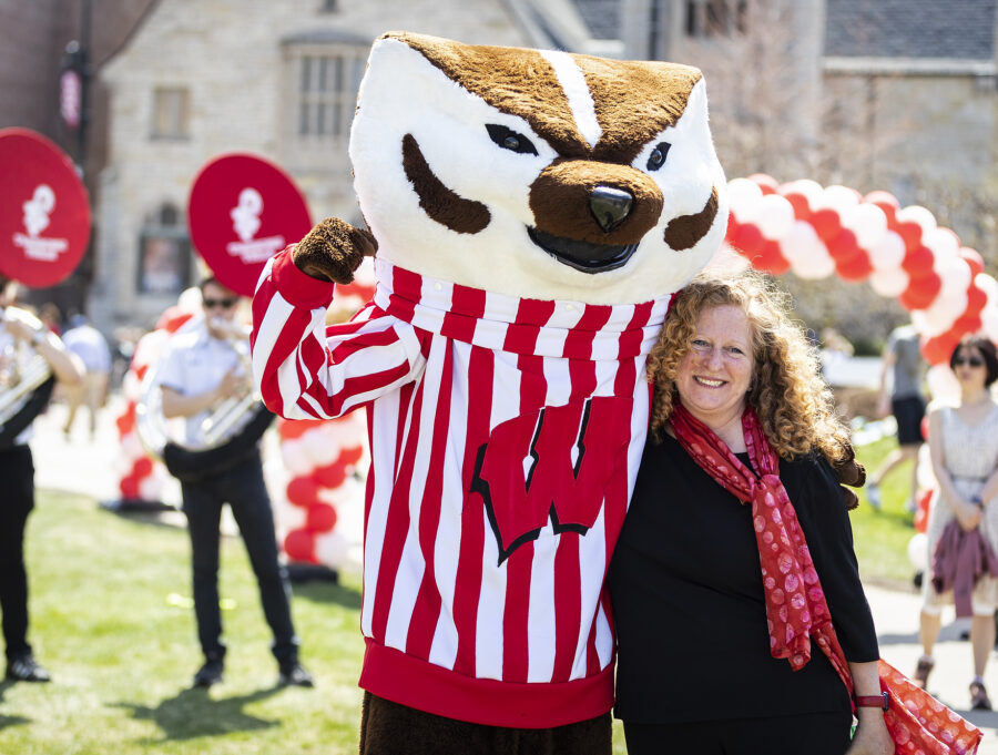 Bucky Badger and Chancellor Jennifer Mnookin pose for a picture together on Library Mall.